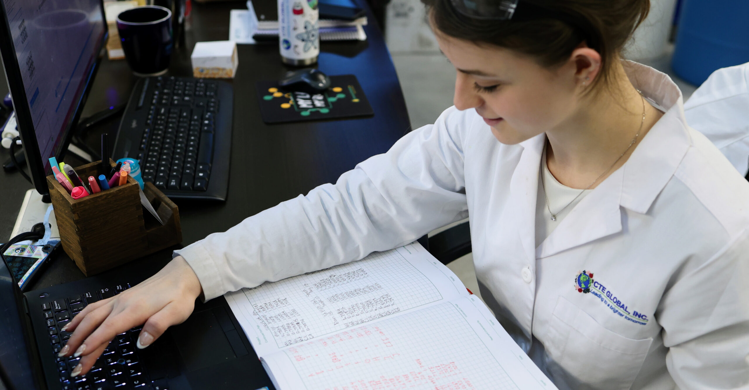 lab technician examining contents of a beaker